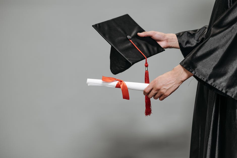 Image depicting a person holding a graduation cap and a certificate, symbolizing education and certification in case management.