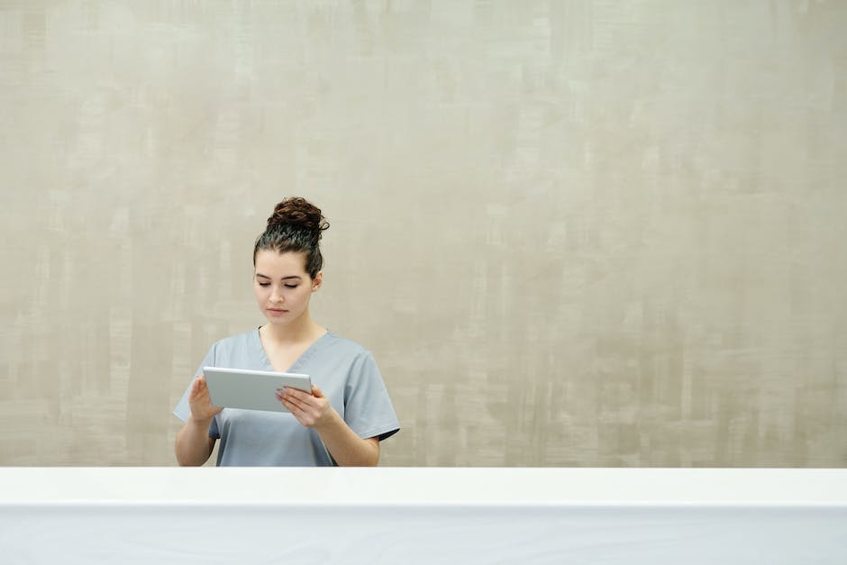 Image of a hotel reception desk with a person talking to a hotel staff member, representing direct booking with hotels strategies.